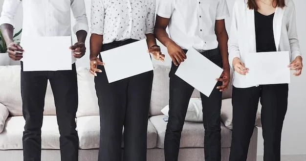 A close-up shot of a diverse group of hands holding up a document with the words