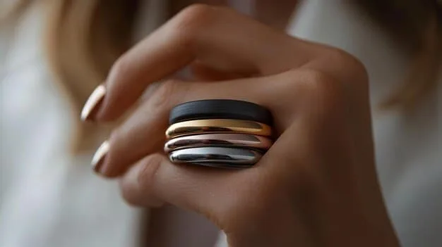 A detailed shot showcasing various ring styles (stacking rings, statement ring, minimalist band) on a hand, highlighting how they can be combined and styled to create different looks. This image is intended to inspire creativity in accessorizing and is directly related to The Ultimate Guide to Jewelry: Choosing the Right Pieces for Every Outfit.