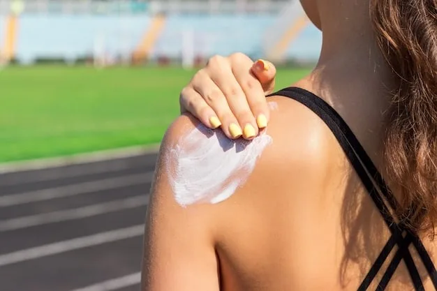 A close-up shot of a person applying sunscreen to their arm. The focus is on the creamy texture of the sunscreen and the way it blends into the skin. The background is blurred, showing an outdoor setting with natural light. Caption: