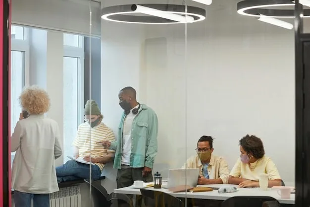 A diverse group of people working together in a modern office space, representing the collaborative nature of the modern workforce. Focus on What Does the Latest US Jobs Report Reveal About Economic Recovery?