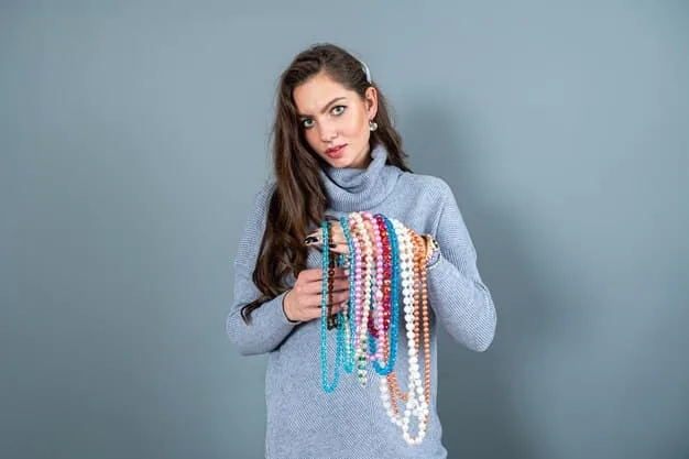 A person thoughtfully selecting an accessory from a small, curated collection of jewelry, belts, and scarves, demonstrating the power of accessories in a capsule wardrobe.