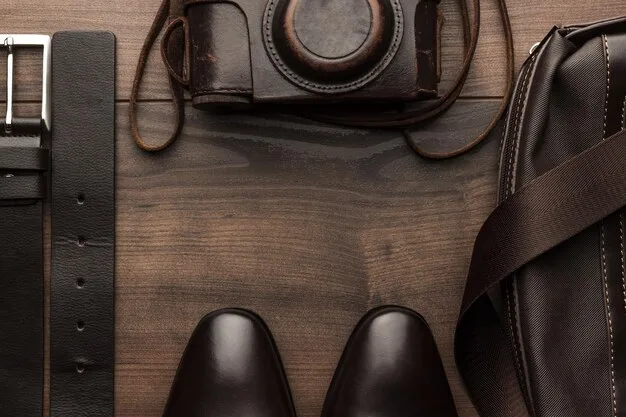 A detailed shot of various leather belts and polished leather shoes, arranged neatly on a wooden surface, showcasing different textures and shades of brown and black, emphasizing quality accessories.