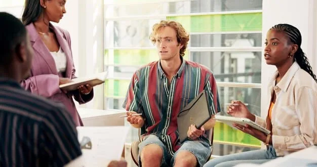 A diverse group of people sitting attentively in a communal space, suggesting a legal clinic or community meeting, with a focus on their engaged expressions.