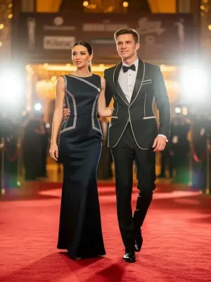 Zendaya and Tom Holland on red carpet, showcasing coordinated high-fashion outfits