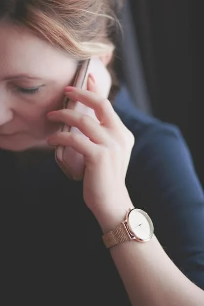 A close-up shot of a woman's hands adjusting a sleek, modern watch on her wrist, with a chic leather handbag and a polished laptop visible in the soft-focus background, conveying professionalism and attention to detail.