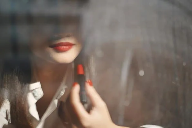 A woman's hands meticulously applying a subtle lip balm, with a blurred background of a modern, minimalist office desk, highlighting personal care in a professional context.