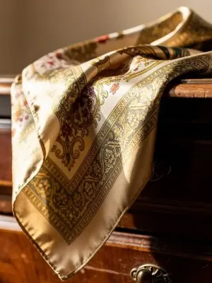Authentic vintage silk scarf with classic pattern on antique dresser