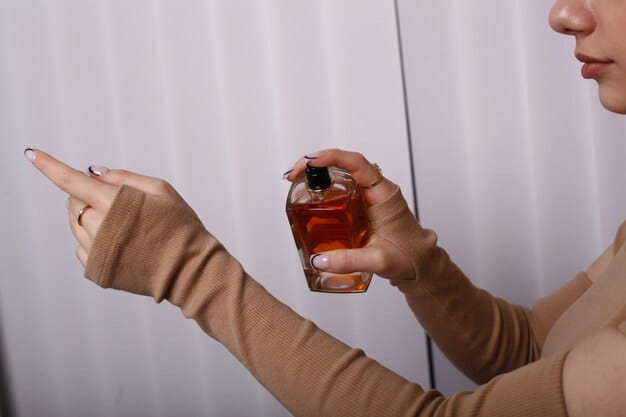 A close-up shot of hands expertly spraying perfume, demonstrating a careful and strategic application technique. The background should be softly blurred, putting the focus squarely on the act of fragrance application.