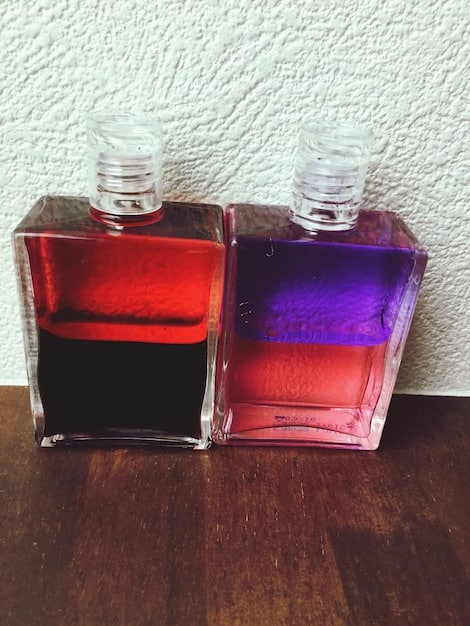 An image displaying two perfume bottles side-by-side, one genuine and the other counterfeit, with visible differences in packaging and color.