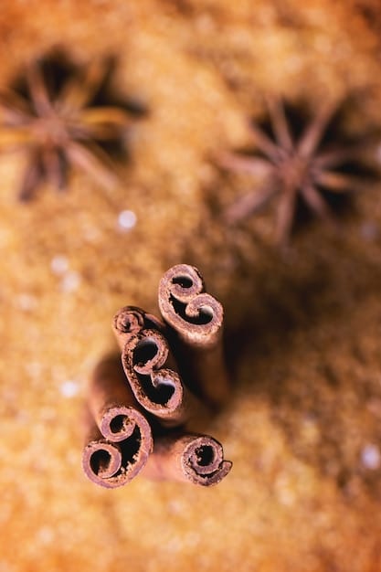 A close-up shot of raw fragrance ingredients, including vanilla beans, sandalwood chips, and amber resin, arranged aesthetically on a wooden surface. The image is warm and inviting, highlighting the natural textures and colors of the ingredients.