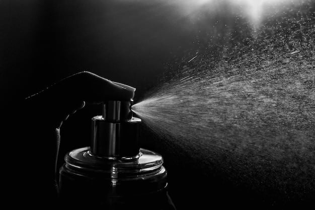 A detailed shot of a perfume atomizer spraying a fine mist of fragrance. The background is dark, allowing the droplets to be clearly visible, highlighting the dispersion and application of the perfume.