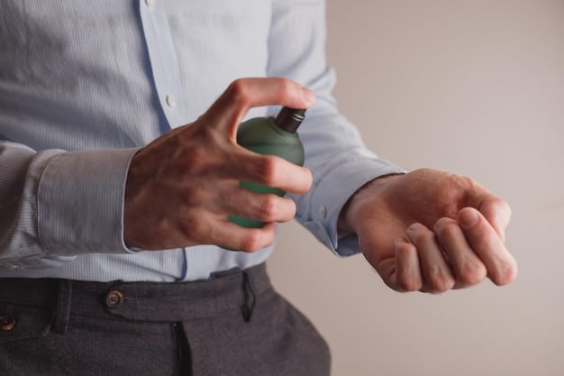 A photograph of a person's wrist being sprayed with perfume from a bottle. The focus should be on the point of contact where the perfume meets the skin, showing the glistening droplets. The lighting should be soft to highlight the perfume without washing out the skin tone. The person appears to be a fragrant professional.