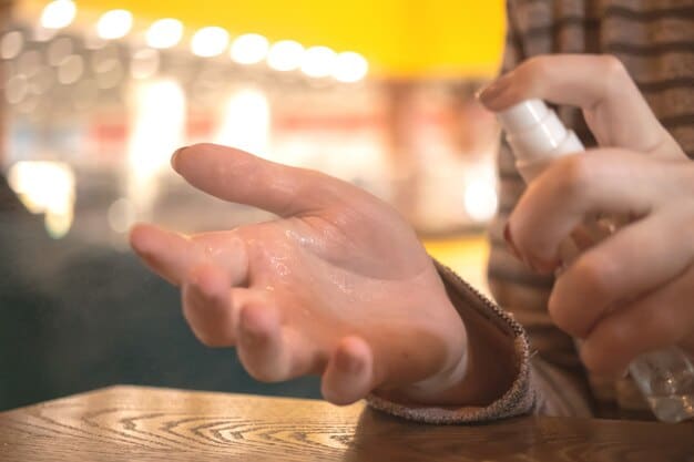 A close-up shot of a person's hand spraying Eau de Toilette onto their wrist, with a blurred background suggesting a casual, daytime setting.