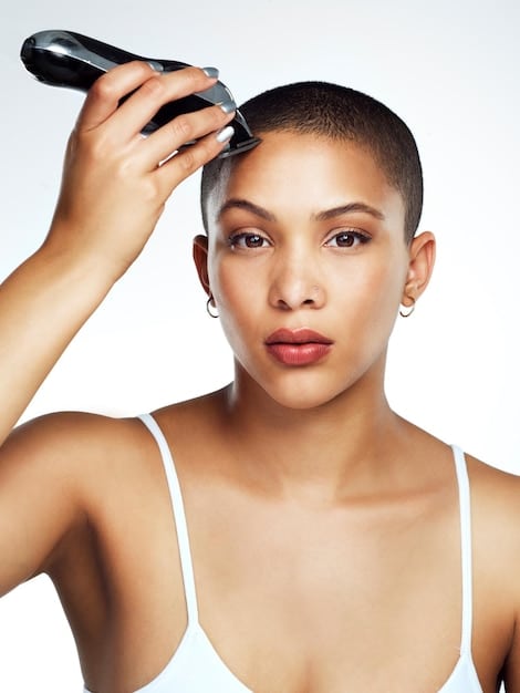 A close-up shot of a makeup artist applying foundation to a model's face using a blending sponge. The focus is on the texture of the foundation and the blending technique, showcasing the importance of a seamless finish.