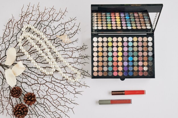 A collection of high-end bridal makeup products arranged neatly on a vanity. The products include foundation, concealer, eyeshadow palettes, lipstick, and blush.