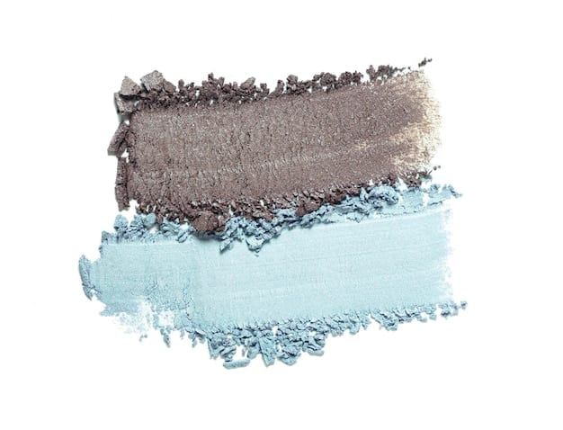 A split image showing two different eyeshadow looks. On one side, a monochromatic eyeshadow look featuring various shades of pink. On the other side, a cut-crease eyeshadow look with bold lines and contrasting colors, showcasing trendy eyeshadow blending techniques.