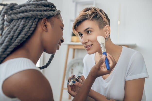 A makeup artist applying a foundation with cool undertones to a model with fair skin. The focus is on the seamless blend and the natural, radiant finish that the foundation provides. The lighting is soft and flattering.