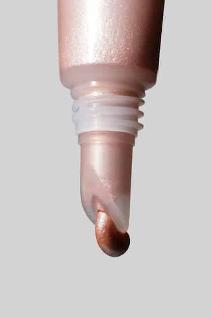 A product close up showing different types of highlighters (powder, cream, liquid) swatched on an arm, demonstrating the different textures and shimmer intensities. Each swatch is labeled with its type.