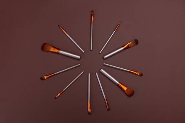 A collection of various makeup brushes laid out on a table, including blending brushes, shader brushes, and pencil brushes. The brushes are clean and arranged neatly, emphasizing their importance in creating a professional makeup look.