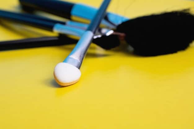A close-up, overhead shot of a brush cleaning station. It features a silicone brush cleaning mat, a bowl of soapy water, and several clean and drying makeup brushes. The scene is intended to emphasize the importance and process of brush cleaning.