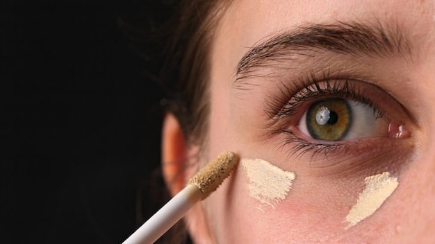 A split image showing the under-eye area of a person before and after applying concealer. The 'before' side clearly shows dark circles and some puffiness, while the 'after' side is brightened and even-toned with a natural finish.