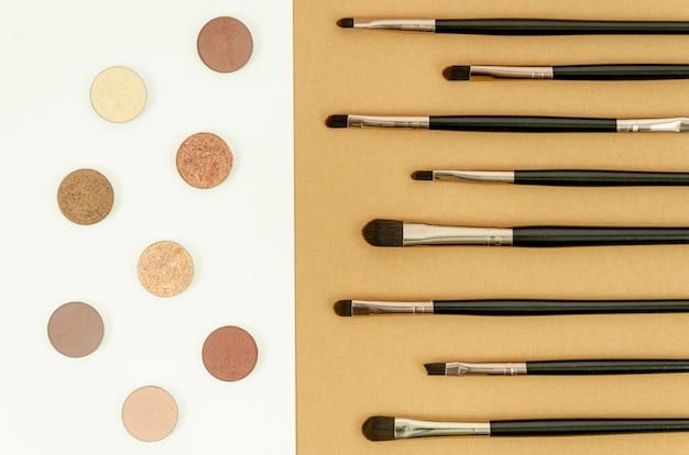 A close-up shot of various eyeshadow brushes with different shapes and sizes, arranged in a holder. Some brushes have eyeshadow pigment on them, showcasing the variety of colors used in eye makeup.
