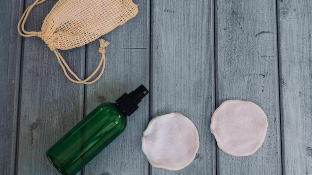 A close-up photo of reusable makeup remover pads and silicone makeup sponges on a wooden surface, showcasing their eco-friendly and cost-saving nature.