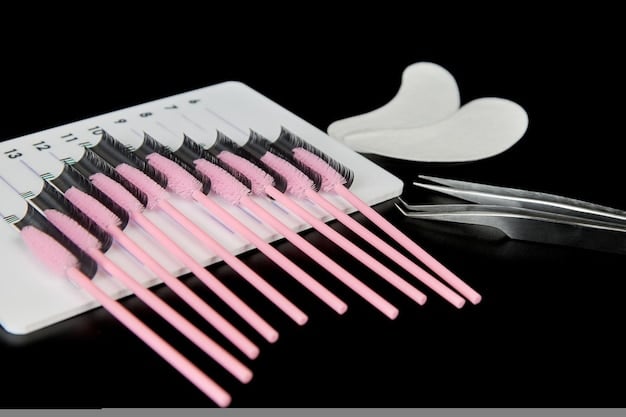 A selection of different types of false eyelashes laid out on a table, including strip lashes, individual lashes, and magnetic lashes, along with various application tools.