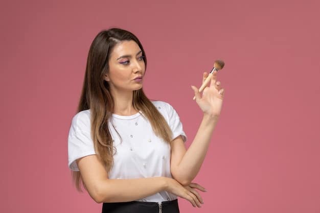 A makeup artist demonstrating the application of a cream blush to a model's cheek, showcasing the blending technique and natural color payoff.