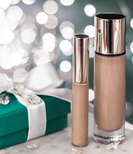 Close-up of various lightweight makeup products arranged neatly on a vanity, including tinted moisturizer, concealer, cream blush, and clear brow gel. Soft, diffused lighting highlighting the textures of the products.