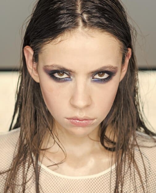 Collage showing three variations of smoky eye makeup: a classic black smoky eye for evening, a softer brown smoky eye for daytime, and a colorful smoky eye with jewel-toned eyeshadows for a party.