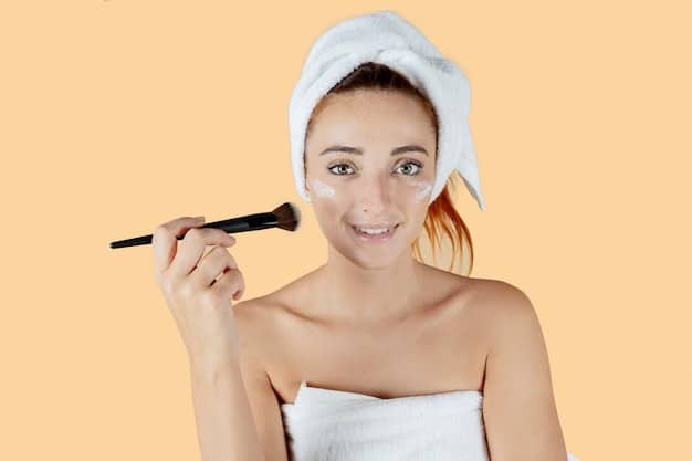 A woman gently exfoliating her face with a soft brush and a mild exfoliating cleanser. The focus is on the gentle circular motions and the luminous glow of her skin after exfoliation. The background is a clean, minimalist bathroom setting.