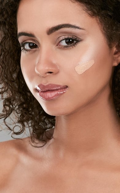 A close-up shot of a woman applying tinted moisturizer to her face with a makeup sponge, showcasing the product's light and natural coverage. Focus on the smooth texture and the dewy finish on her skin.