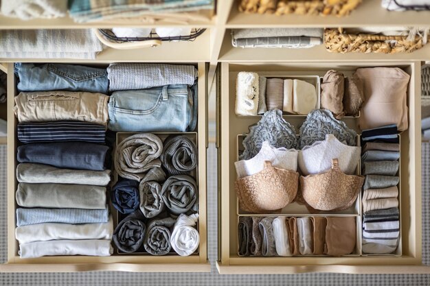 A neatly organized closet section displaying a small, cohesive capsule wardrobe of 10 items on hangers and folded, with an emphasis on neutral colors and versatile fabrics.