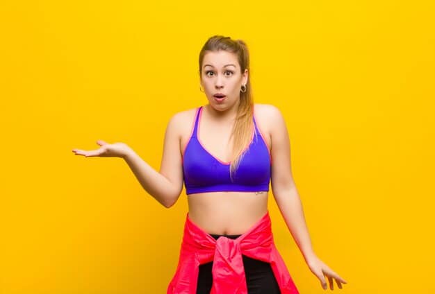 A woman with a pear body shape wearing a vibrant, detailed top that draws attention to her upper body, paired with dark, straight-leg trousers that skim gracefully over her hips and thighs. She looks confident and stylish.