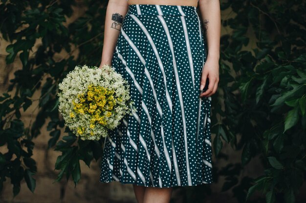 A close-up shot of a chic outfit combining a striped top and a floral skirt, showcasing how the patterns and colors beautifully intertwine without clashing.