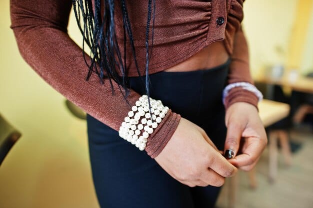 A detailed shot of an accessorized outfit featuring mixed prints, highlighting a solid color belt and simple jewelry that complement the patterns without overwhelming them.