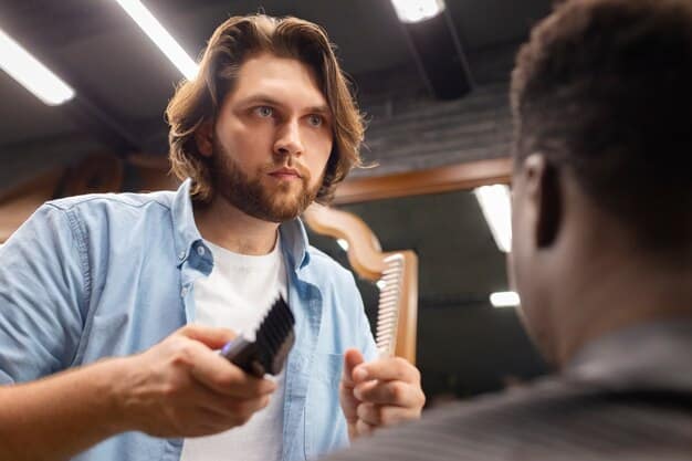 A man getting a professional haircut in a barber shop, illustrating attention to detail and hair shaping.