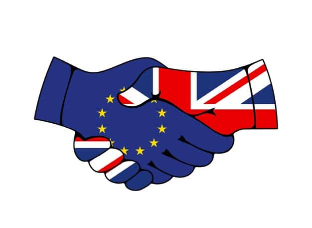 A handshake between two national flags (e.g., US and another country) over a stylized map or globe, representing international cooperation and trade agreements for supply chain resilience.
