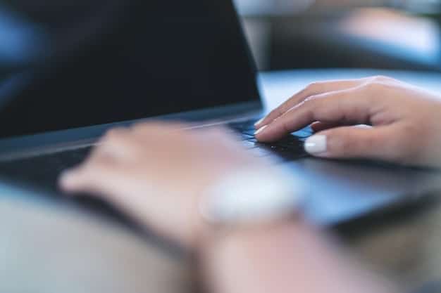 A close-up shot of a person's hands typing on a laptop, representing the technology sector and its contribution to job growth. Focus on What Does the Latest US Jobs Report Reveal About Economic Recovery?