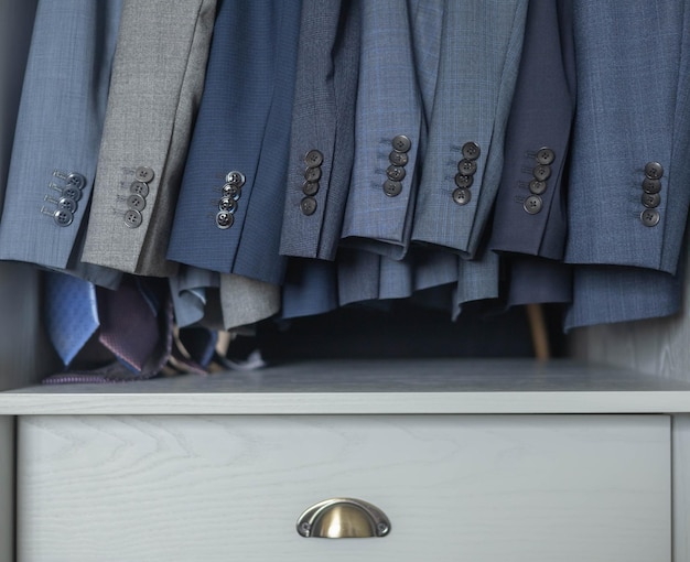 An organized closet showcasing essential interview attire items: a navy blazer, a white collared shirt, a gray pencil skirt, black dress pants, a classic tie, and neutral-colored heels. The image represents a well-prepared and versatile interview wardrobe, emphasizing the importance of How to Dress for a Job Interview: A Style Guide for Making a Lasting Impression.