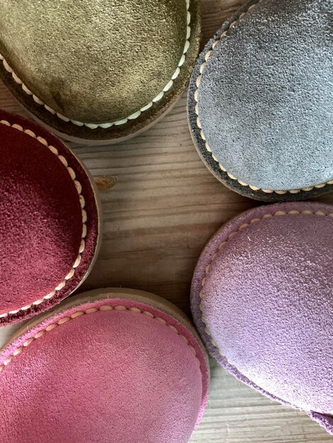 A close-up shot showcasing various handbag textures, including smooth leather, quilted nylon, and canvas. Different hardware details like buckles, zippers, and clasps are visible, each adding a unique touch to the bag's design. Shows the diversity of materials mentioned in 'The Complete Guide to Handbag Styles: From Totes to Clutches'.