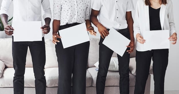 A close-up shot of a diverse group of hands holding up a document with the words 