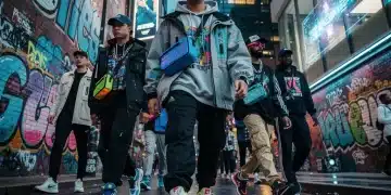 Diverse individuals in vibrant streetwear on urban street, showcasing limited edition fashion drops.